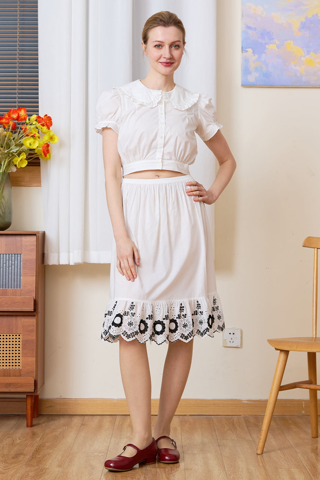 Tudor-Inspired Half Slip: full front view of cotton skirt extender with black floral hem styled in a retro room.