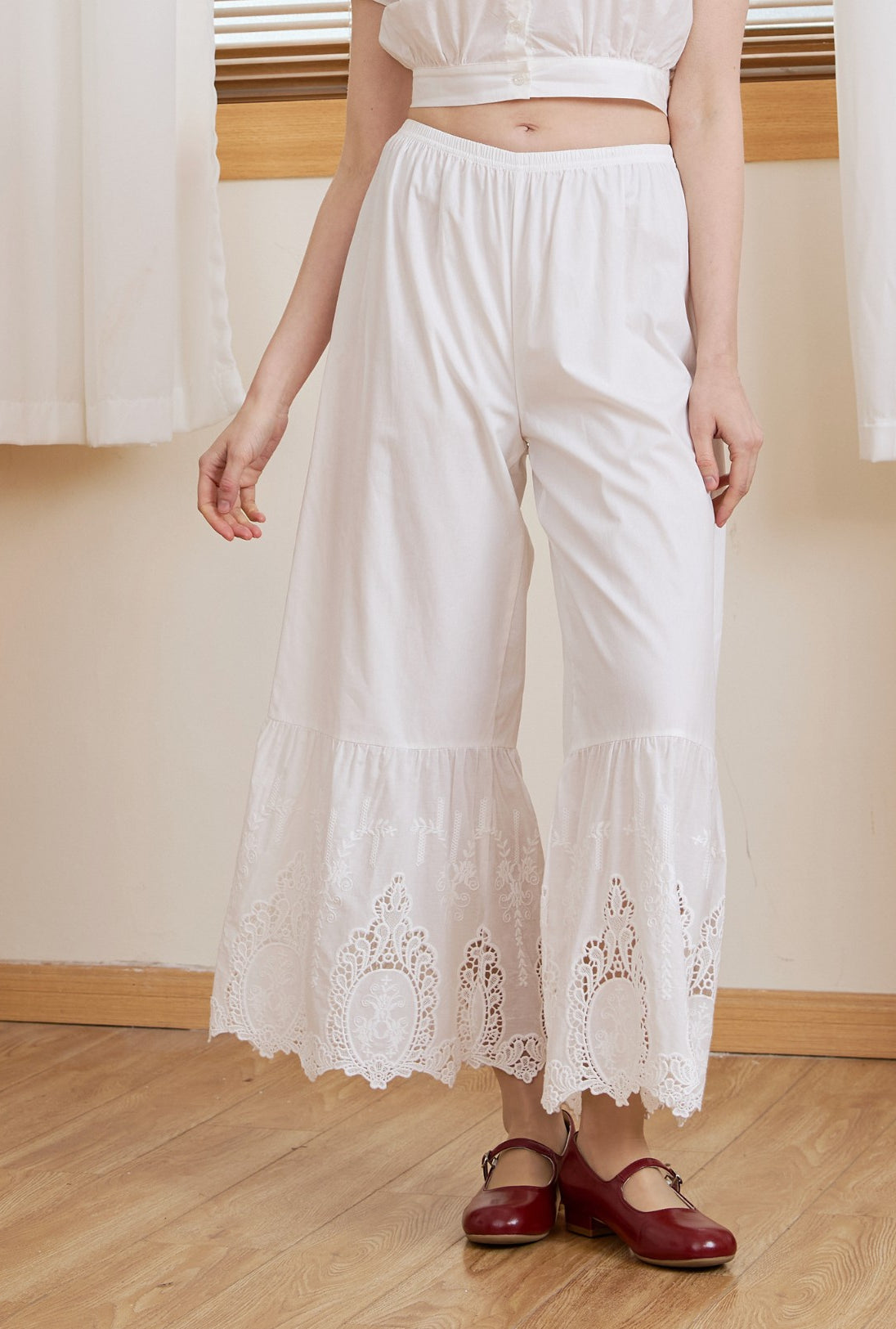 Close up of a model in Ivory Sueasyretro cotton lace bloomers, highlighting oval medallion cutwork.