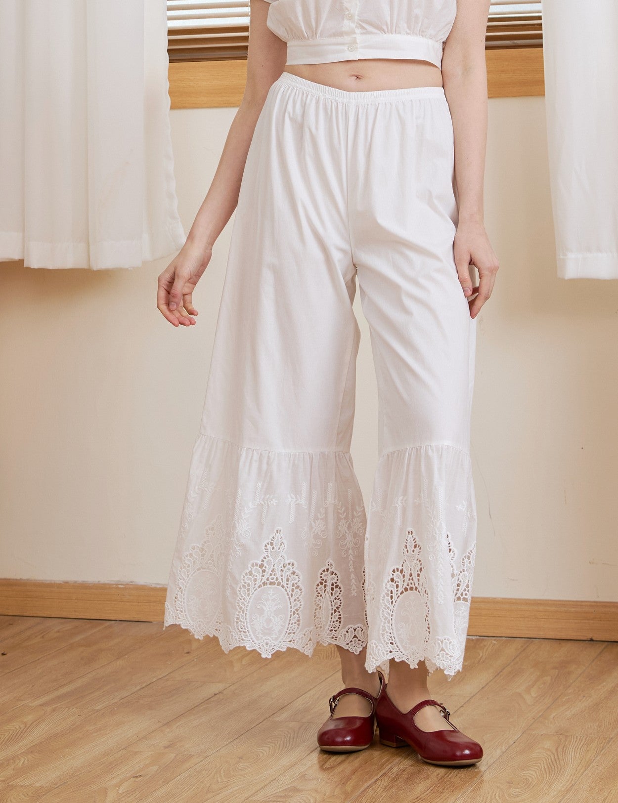 Close up of a model in Ivory Sueasyretro cotton lace bloomers, highlighting oval medallion cutwork.