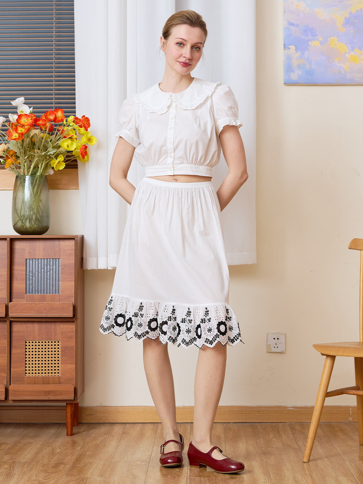 Vintage Petticoat: front view of pure cotton half slip with bold blackwork floral hem, hands behind back pose.