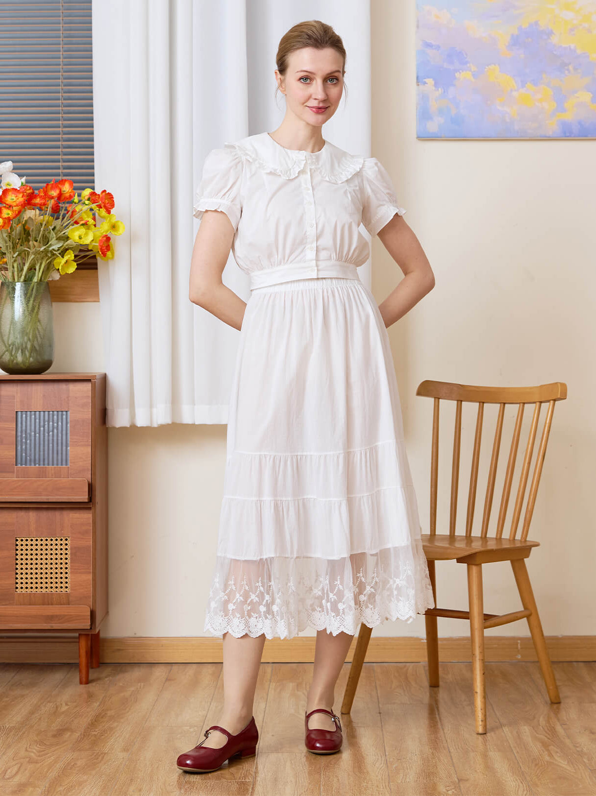 Model wearing the versatile Sueasyretro white cotton A-line skirt slip with tiered lace hem.