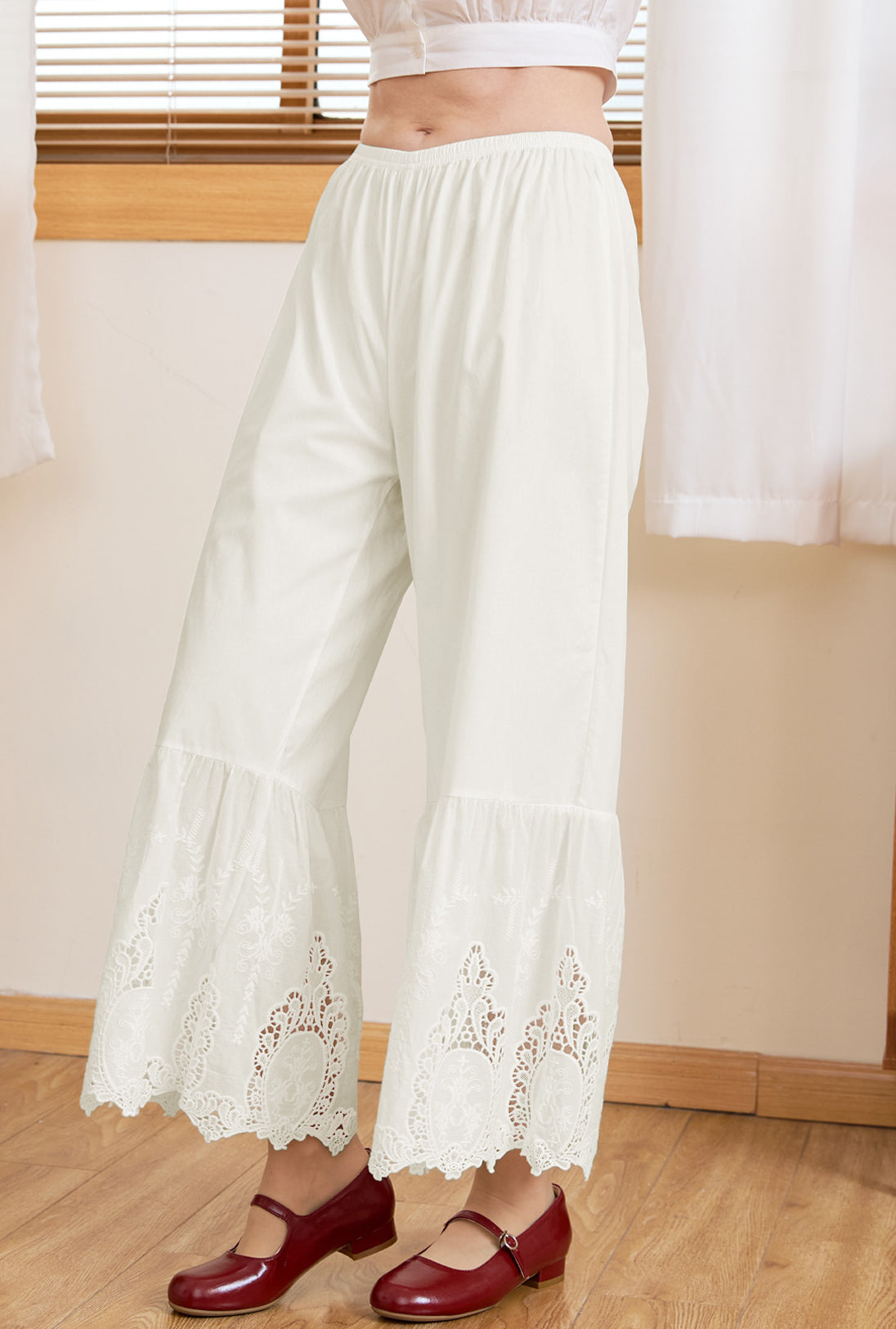 Detail of Victorian-inspired wide-leg lace hems on Sueasyretro cream 100% cotton bloomer pants.