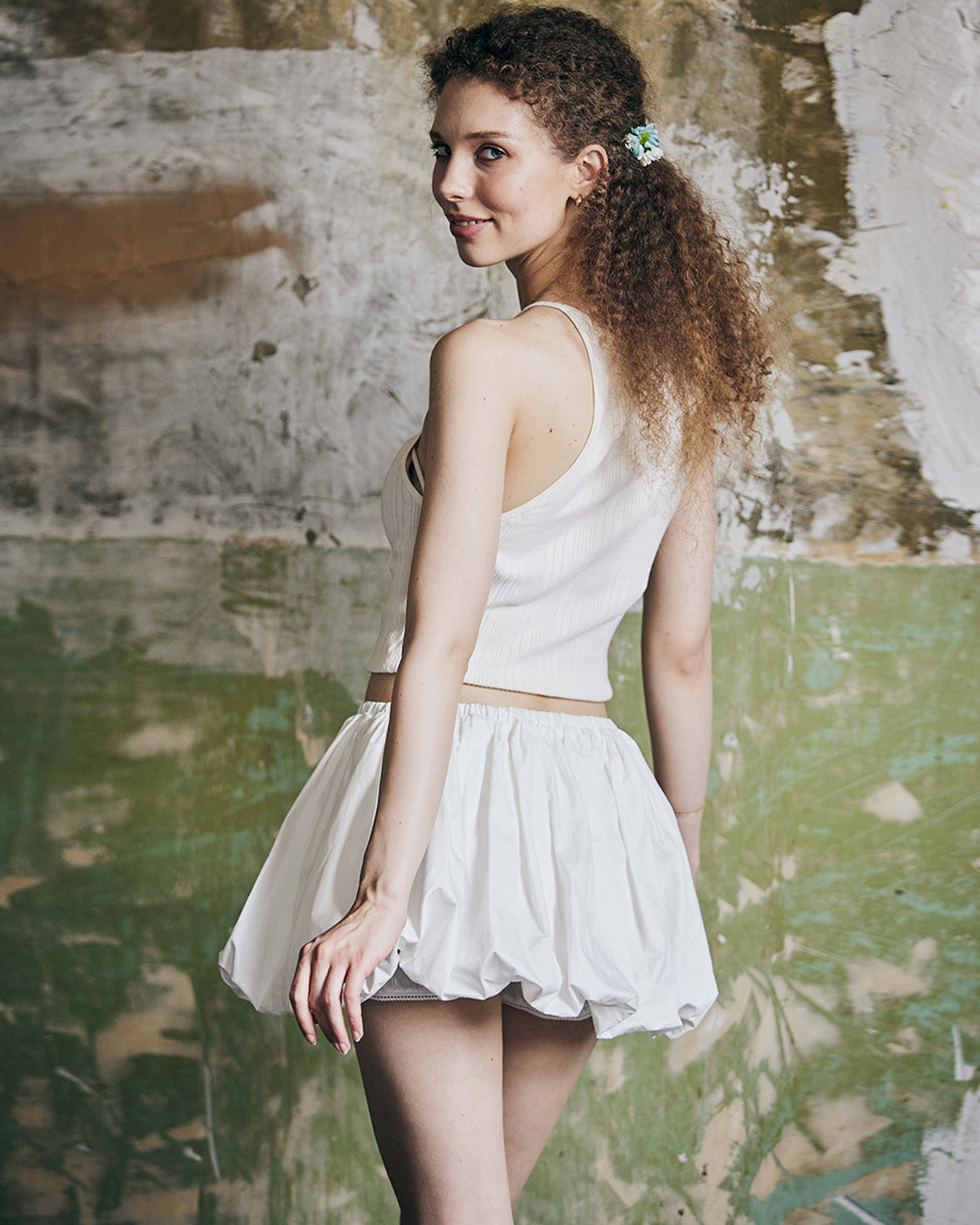 Back view of women's white cotton mini bubble skort with Y2K style pleating