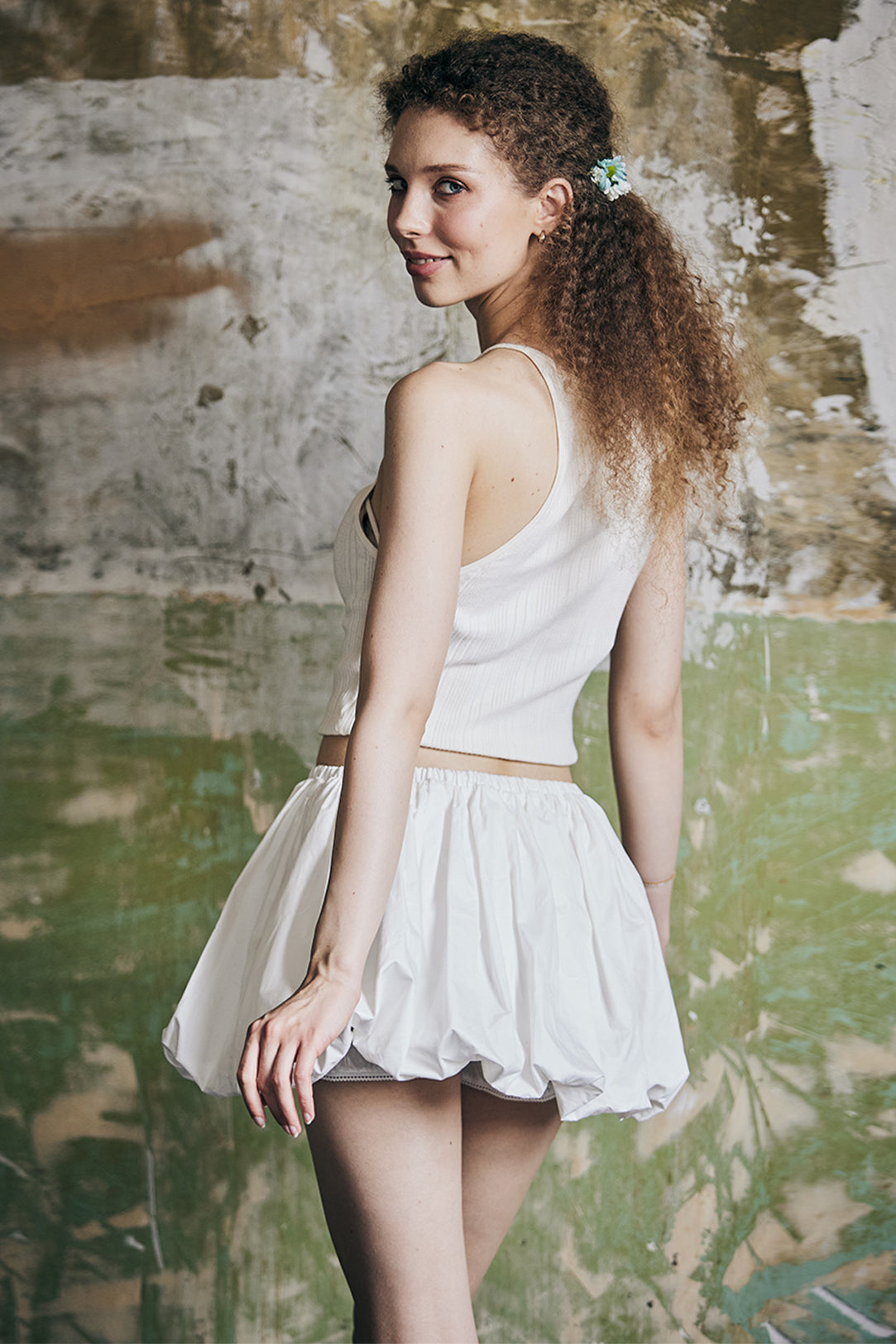 Back view of women's white cotton mini bubble skort with Y2K style pleating