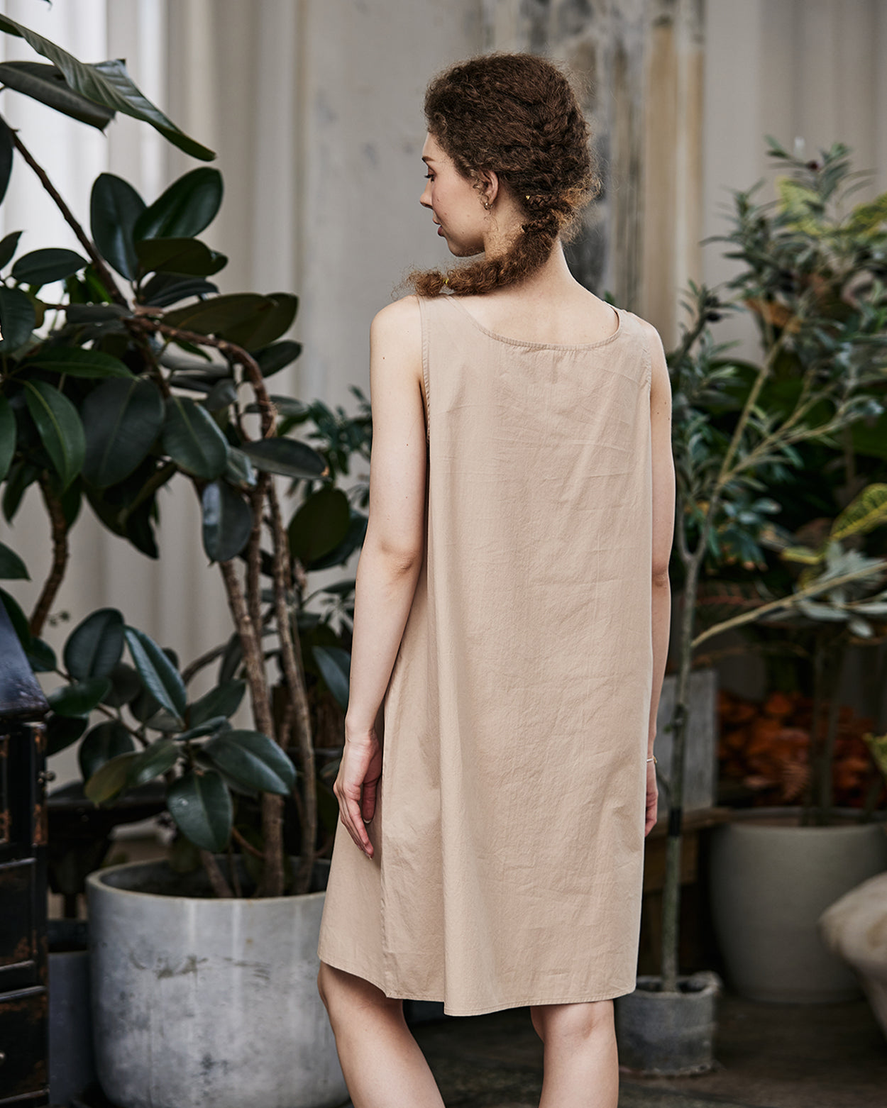 Women's nude cotton full slip with wide straps, showing modesty panel and knee-length design - back view