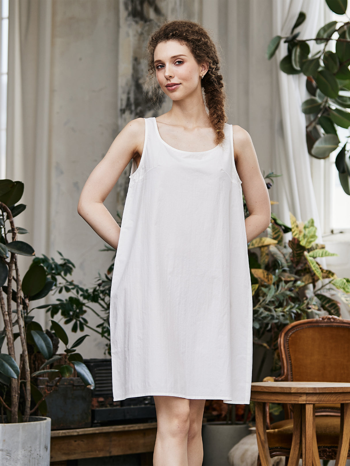 Women's white cotton full slip with wide straps, front view showing modesty panel and knee-length design