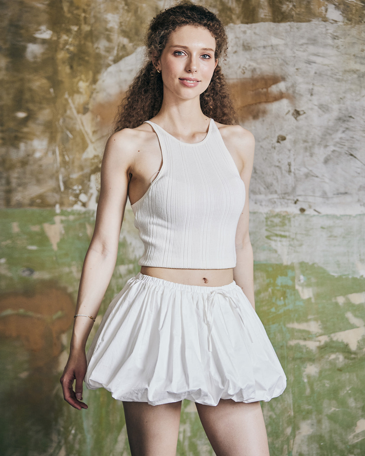 Front view of women's white cotton mini bubble skort with pleated design and Y2K styling