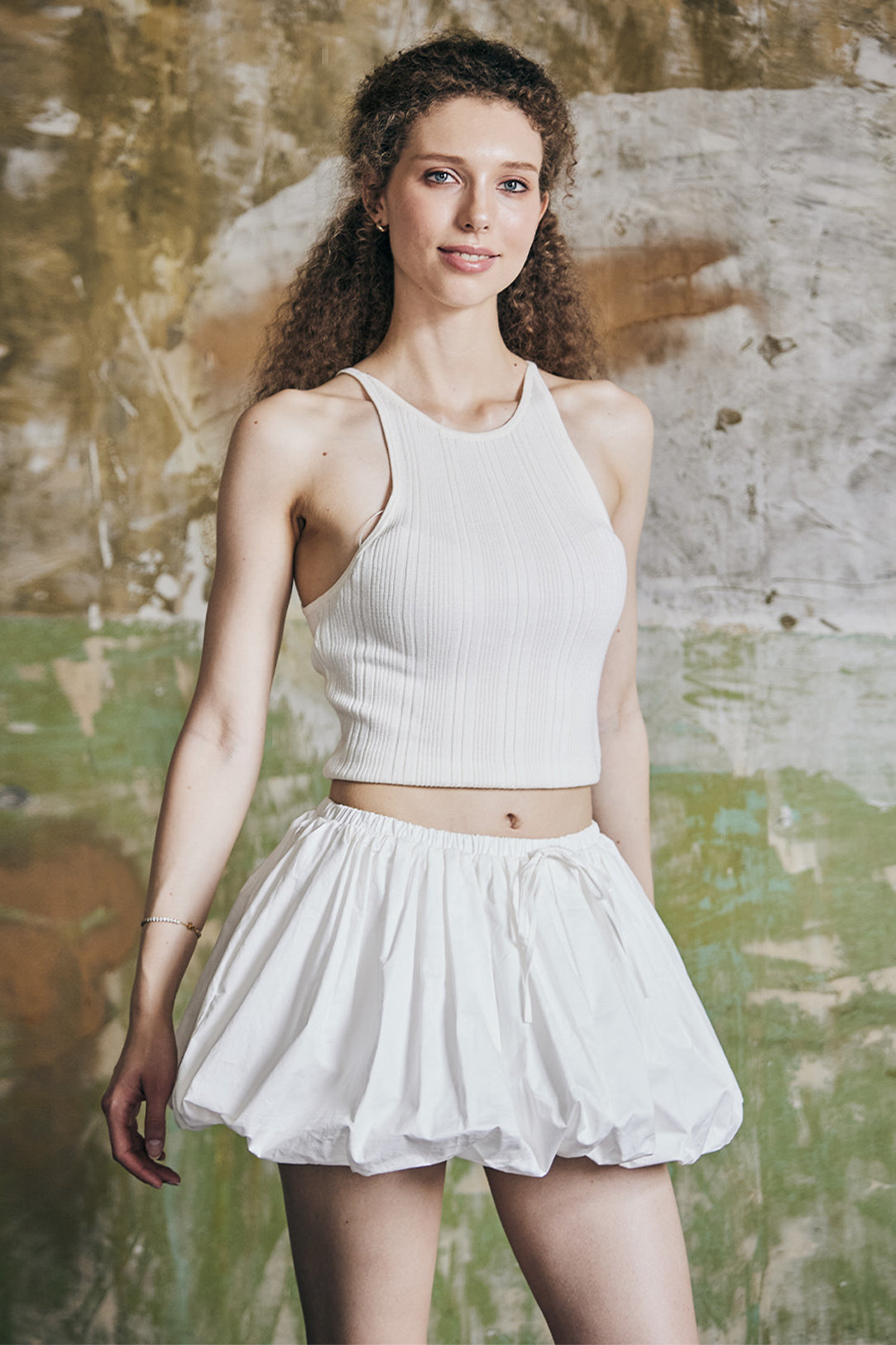 Front view of women's white cotton mini bubble skort with pleated design and Y2K styling