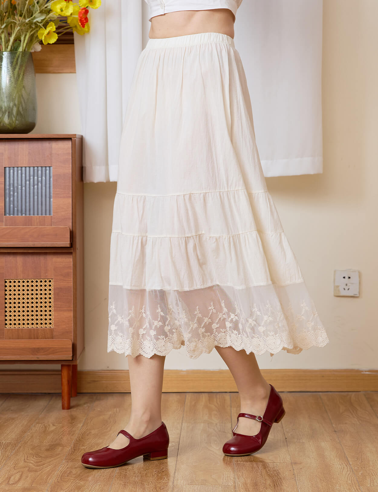 Side close-up of Sueasyretro cream cotton skirt extender showing the tiered panels and lace.