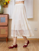 Side close-up of Sueasyretro cream cotton skirt extender showing the tiered panels and lace.