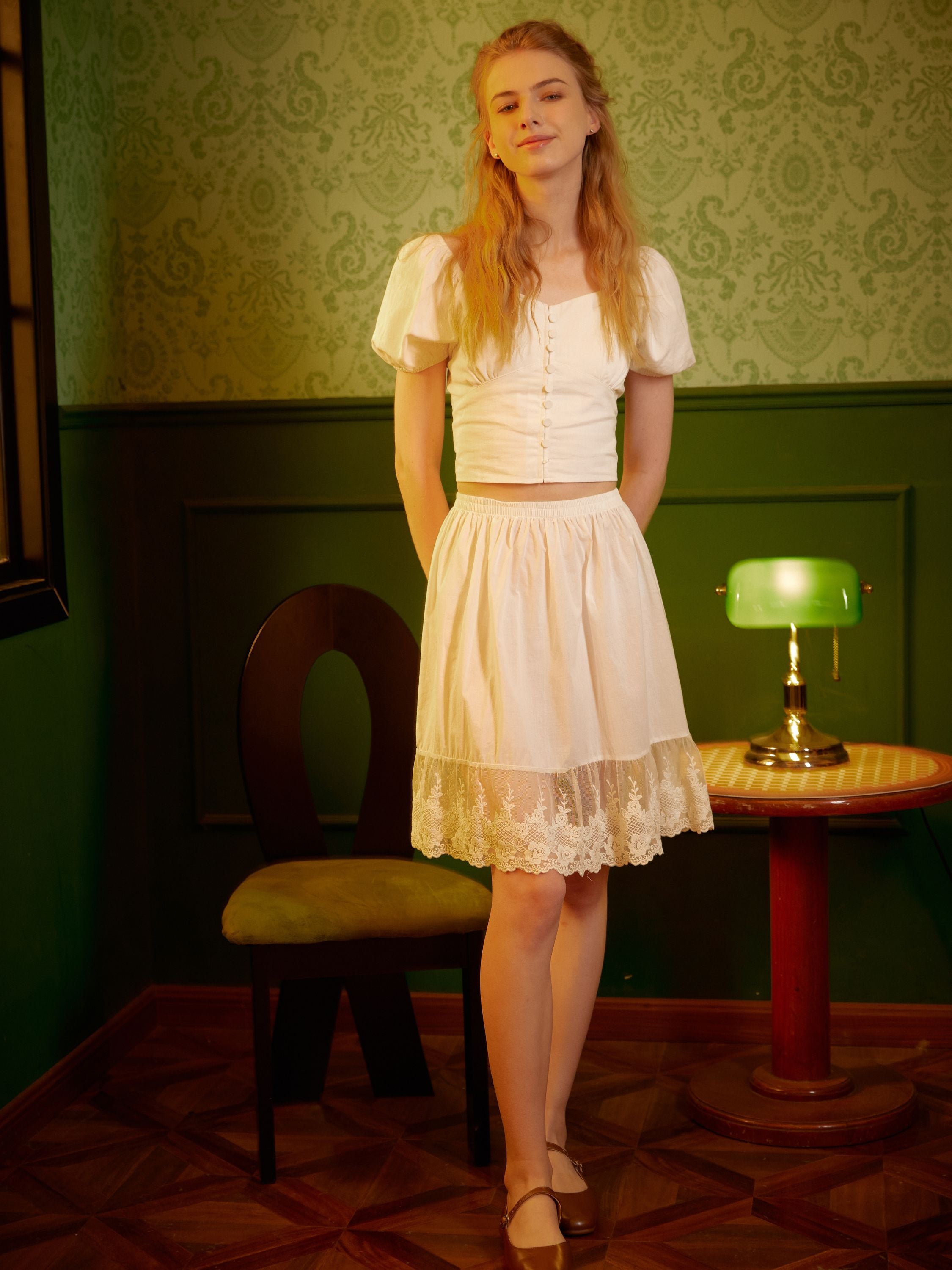 Full-length view of a woman wearing a knee-length cotton half slip underskirt, featuring a breathable upper and an elegant sheer floral lace hem.