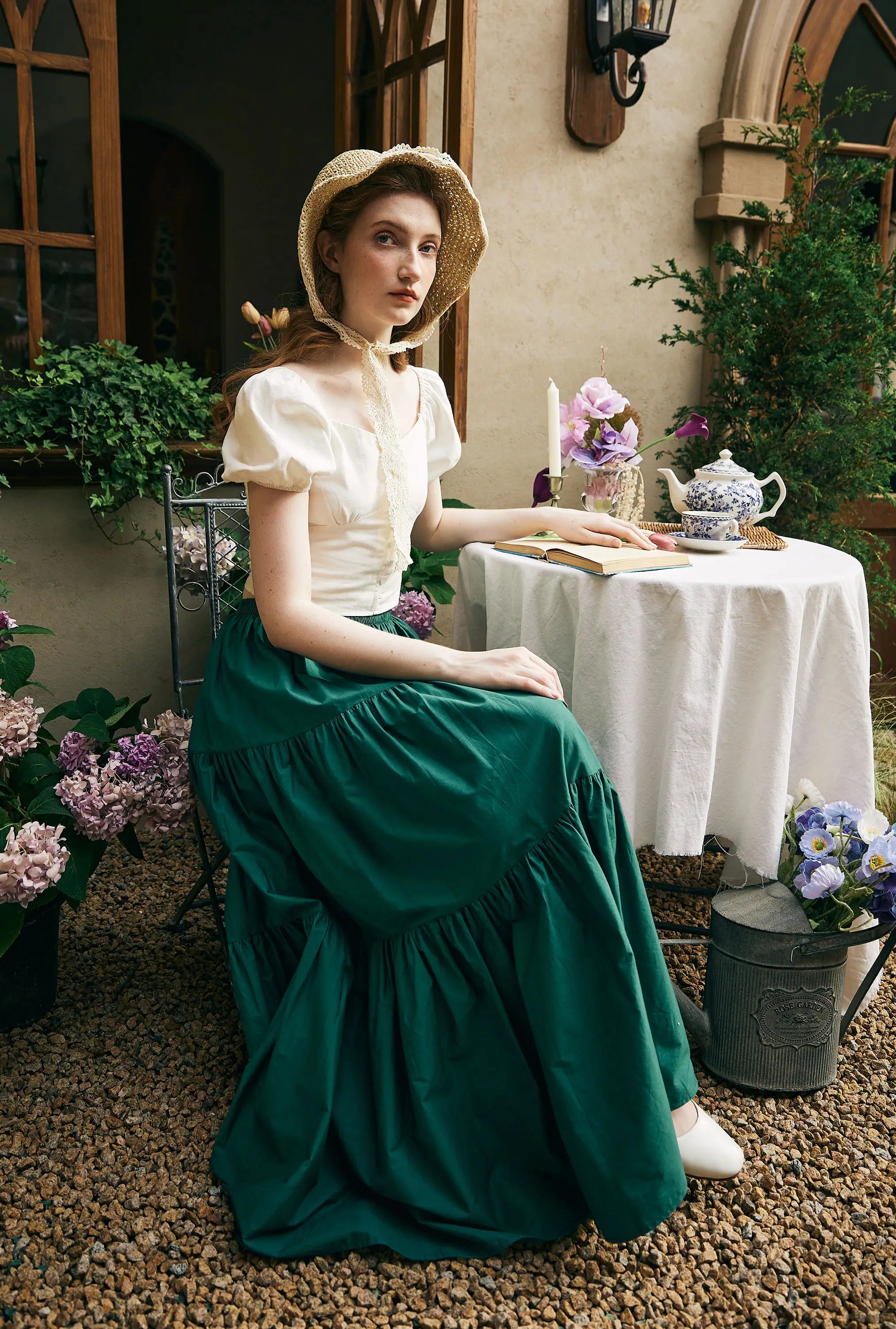 Sueasyretro vintage-inspired women's summer outfit, showcasing a white sweetheart neckline puff-sleeve top paired with a deep green tiered flowy maxi skirt.