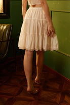 Back view of a handmade cotton petticoat skirt extender, highlighting the comfortable elastic waistband and tiered ruffled design.