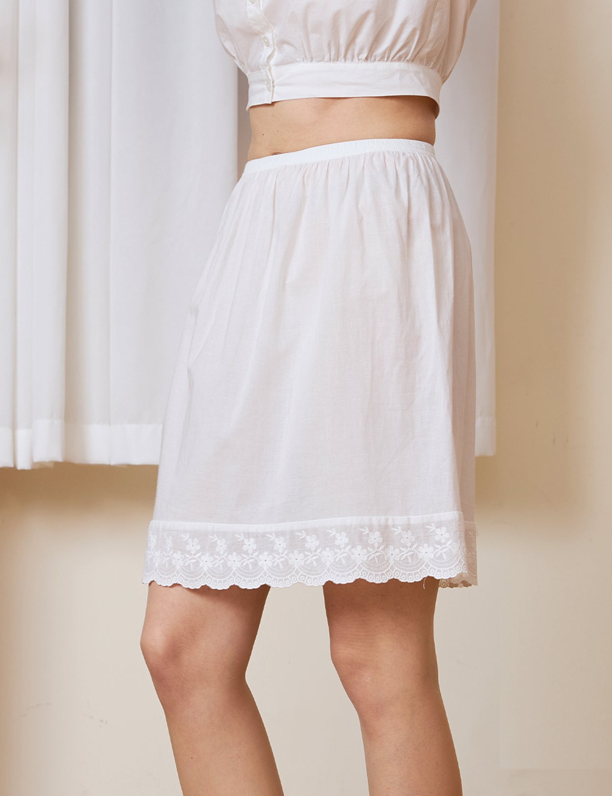 Side view of a crisp 100% cotton vintage-style petticoat underskirt, demonstrating a slight A-line shape and lightweight drape.