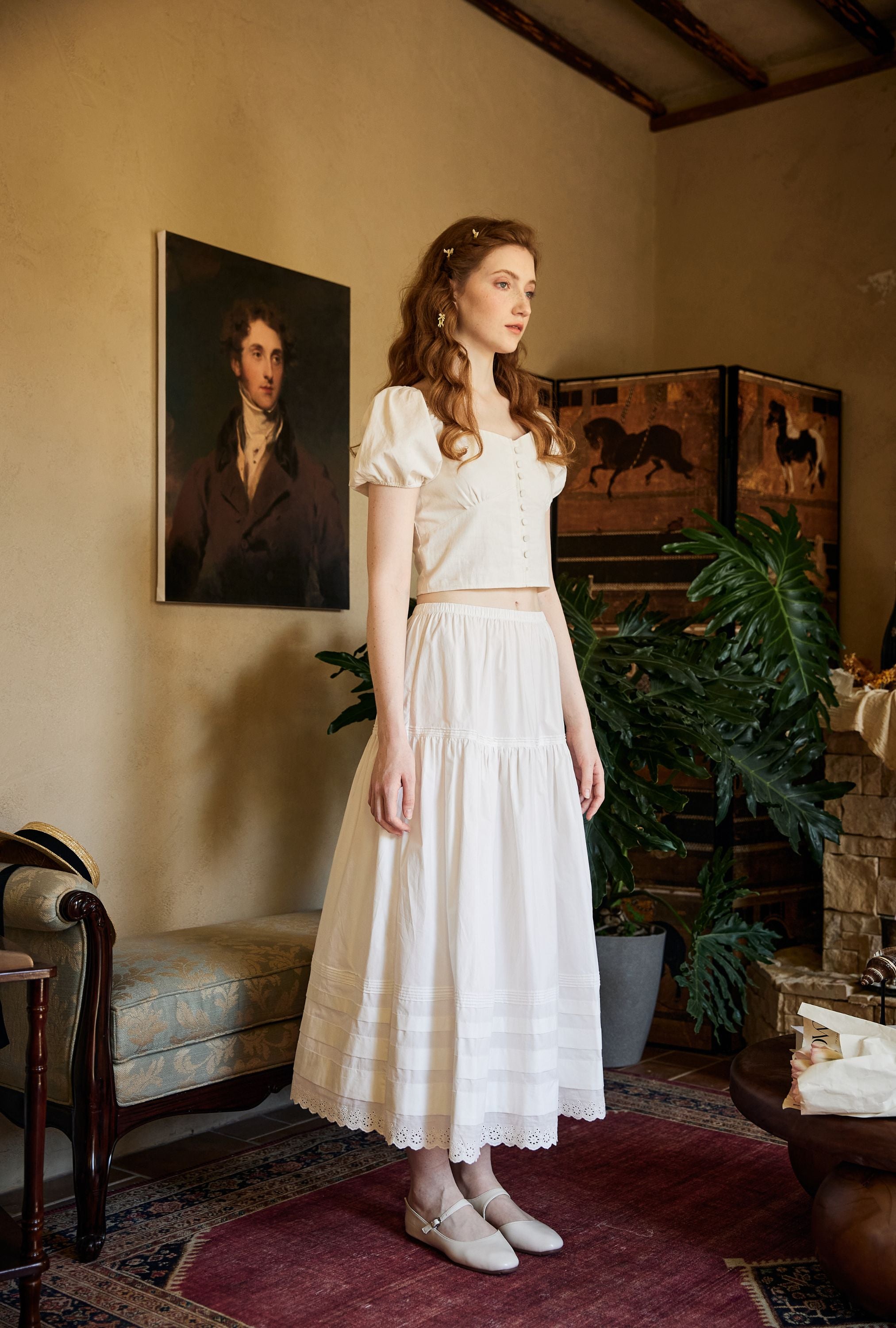 Full-length view of an elegant 100% cotton small A-line petticoat skirt, featuring late 19th-century historical details and lace trims in a vintage room setting.