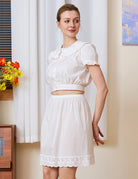 Woman modeling a Victorian-inspired white pure cotton half slip styled as a vintage everyday essential with a matching white top.