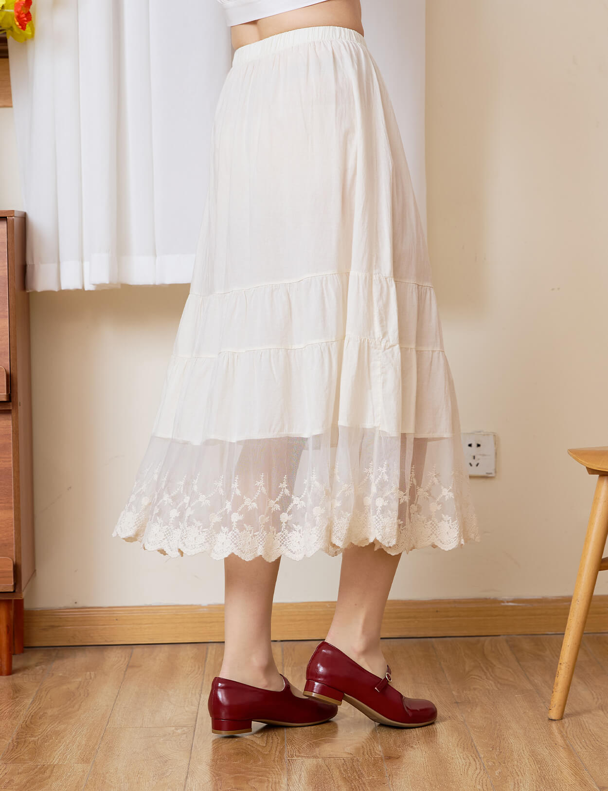 Sueasyretro cream cotton A-line skirt extender, side view showing the tiered lace hem in motion