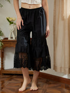 Black cotton bloomer pants by Sueasyretro, featuring a wide sheer Victorian lace hem. Perfect for timeless femininity.