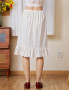 Back view of Ivory cotton petticoat half slip, highlighting the seamless comfort and knee-length floral vine lace trim.