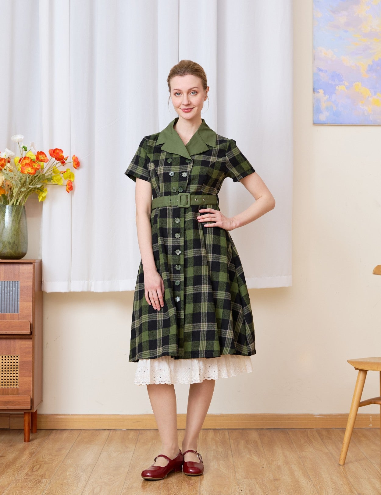 Cream cotton petticoat with floral lace trim peeking under a plaid dress, vintage-inspired layering for a retro look.