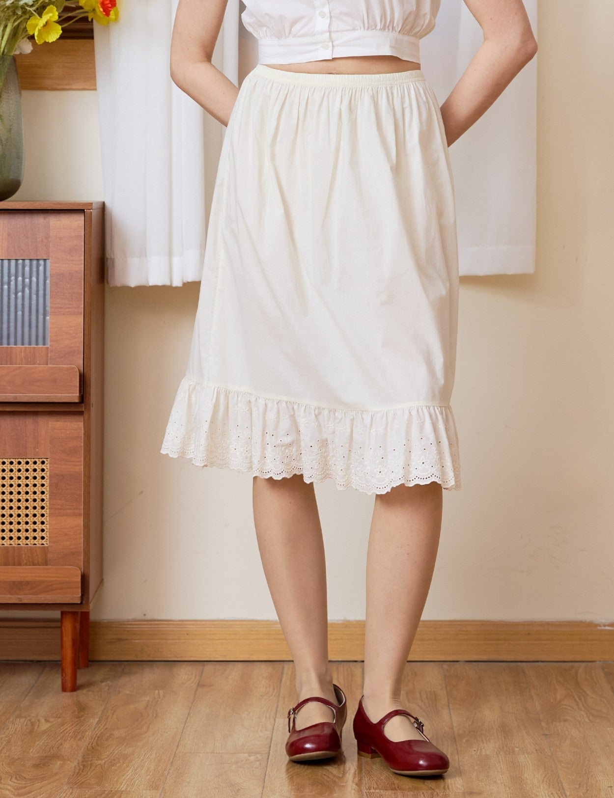 100% cream cotton petticoat featuring an elastic waist and intricate vine pattern lace hem, soft and breathable half slip.