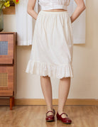 100% cream cotton petticoat featuring an elastic waist and intricate vine pattern lace hem, soft and breathable half slip.