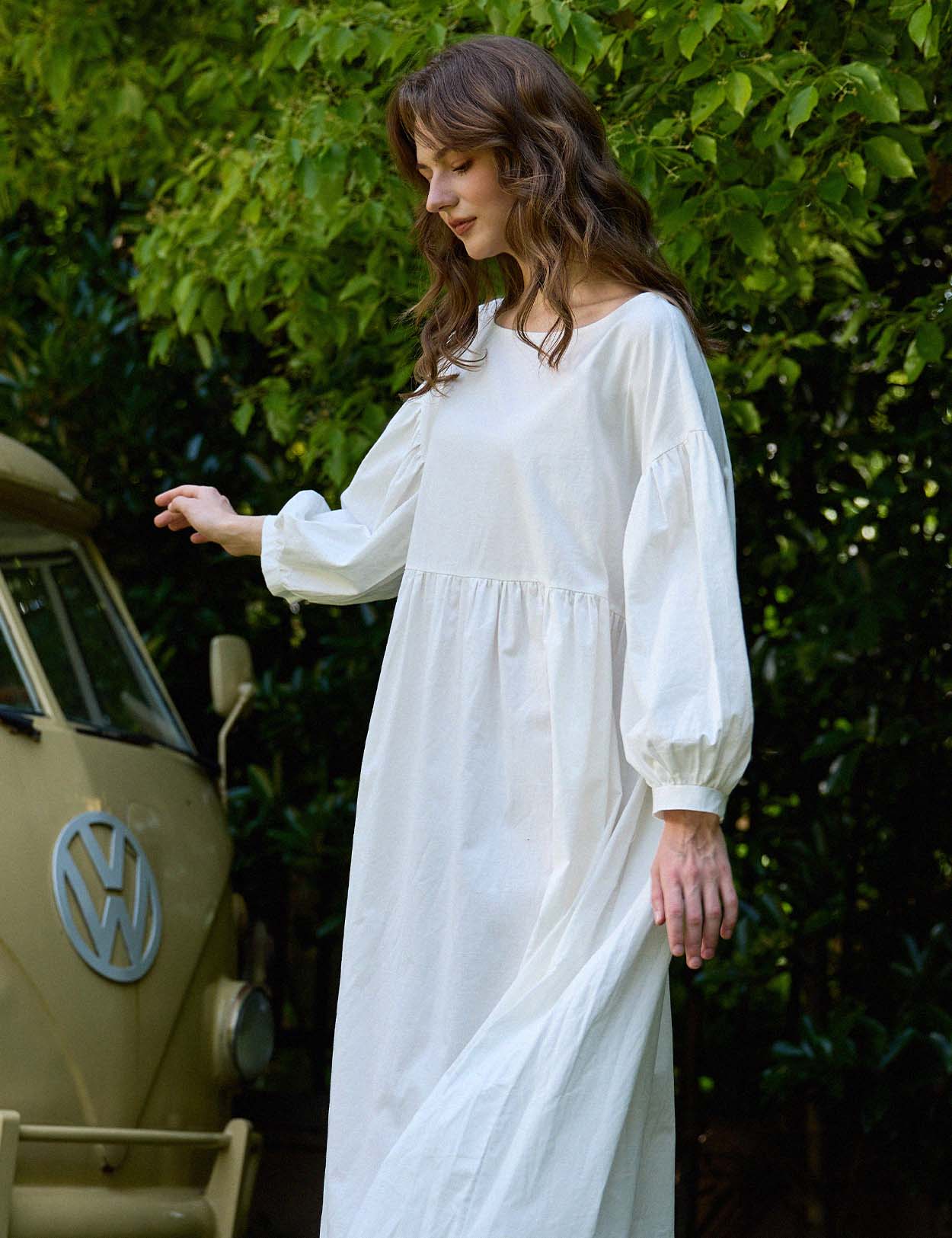Side profile of flowing Sueasyretro white cotton house dress.