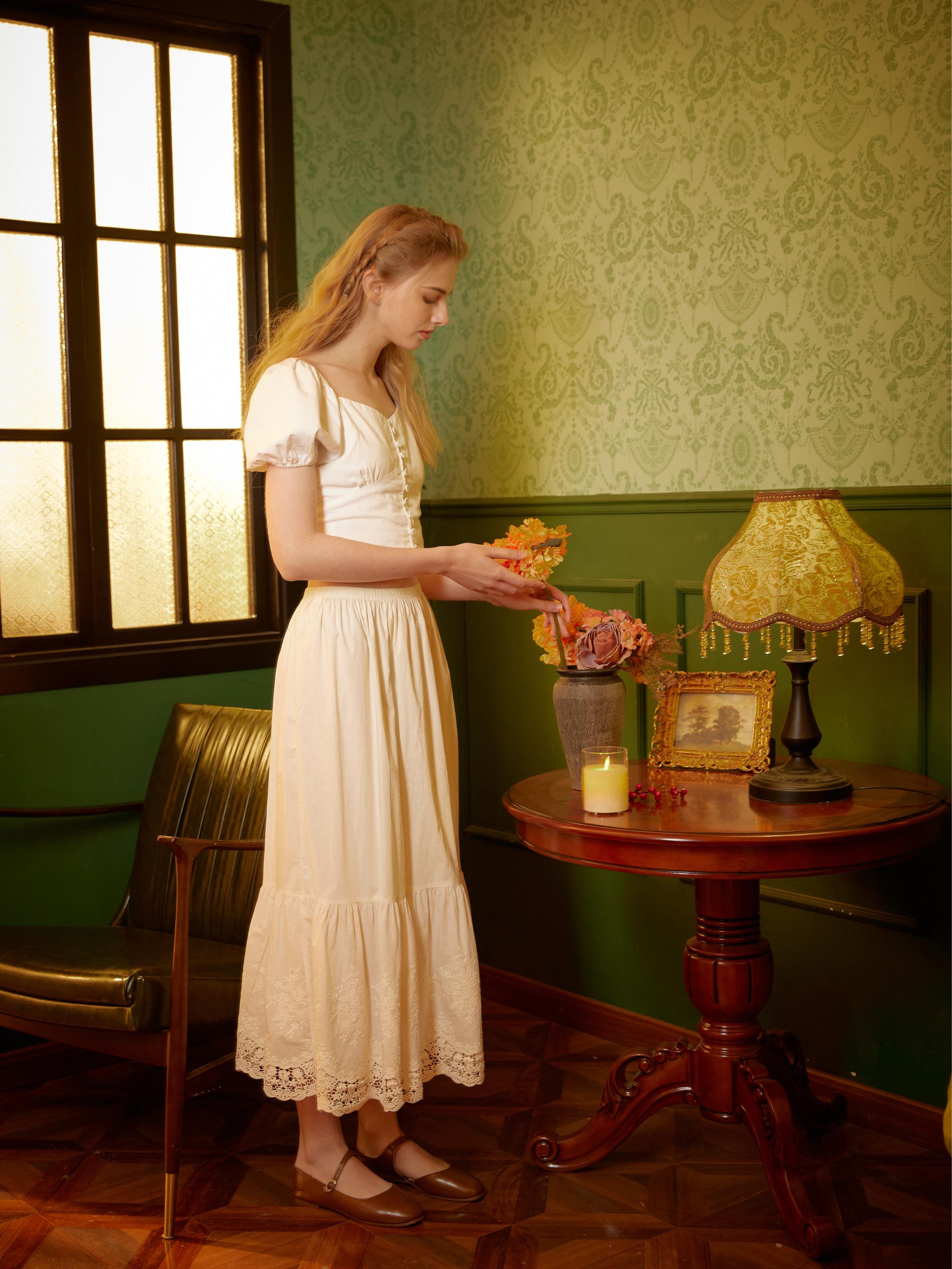 Side standing view of the Sueasyretro midi cotton petticoat lace hem in a vintage room.