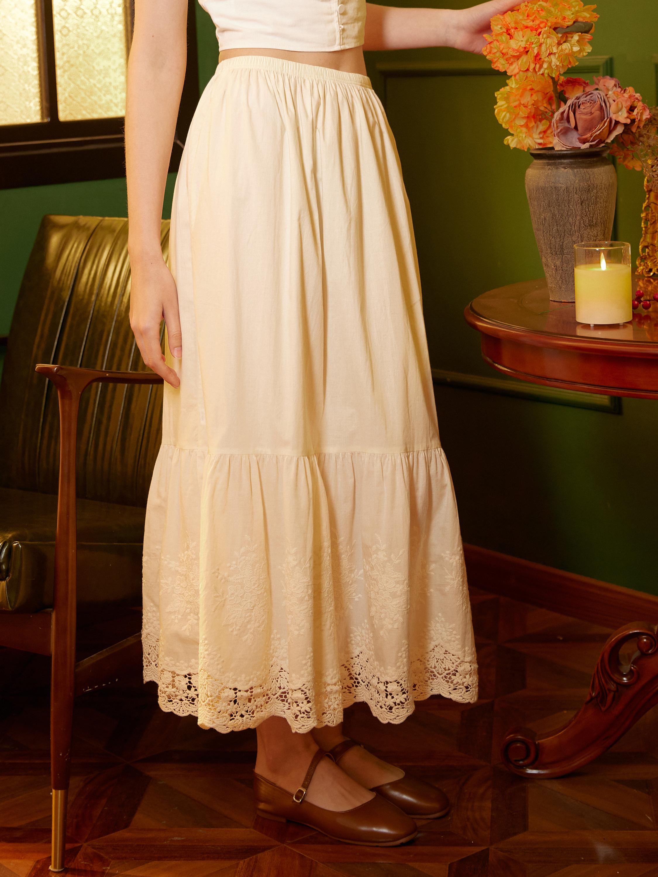 Waist-down shot of the vintage cream midi cotton petticoat lace, showing the scalloped bottom.