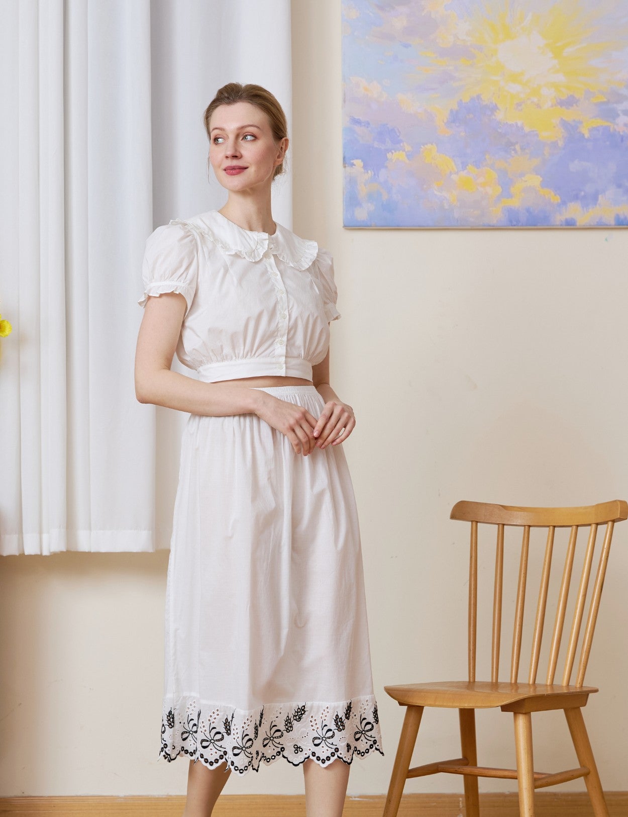Front view of the midi white cotton Petticoat highlighted by Tudor bluework embroidery.