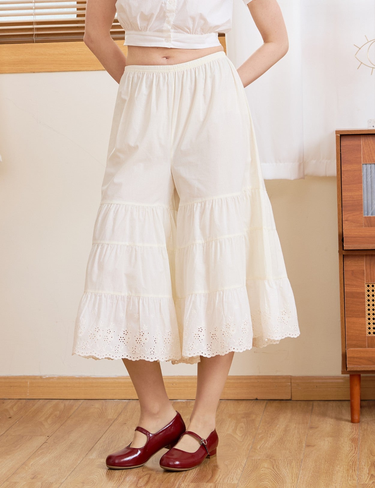 Front view of cream cotton bloomers for women. These vintage bloomer pants feature a flexible elastic waist and tiers.
