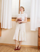 Full body pose in cream cotton bloomers for women. Vintage bloomer pants crafted from pure cotton for everyday comfort.