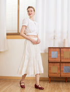 Angled view of the cream wide leg cotton bloomers. Perfect bloomer pants to wear alone or layer under a midi skirt.