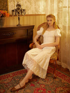 Model sits in a vintage room wearing Sueasyretro Victorian lace bloomers made of soft breathable cotton for comfort.