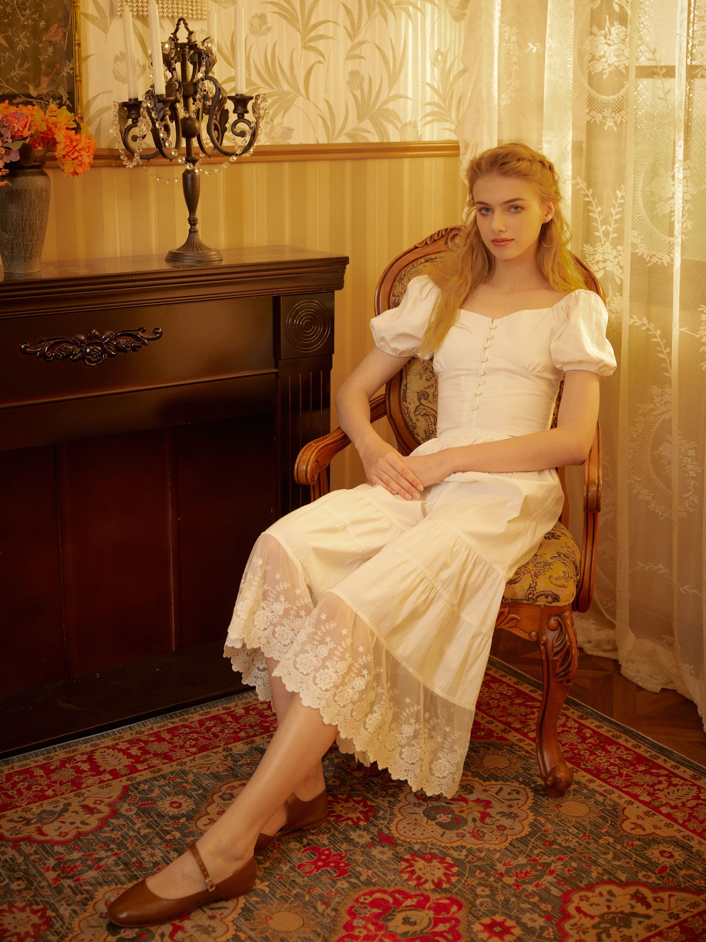 Model sits in a vintage room wearing Sueasyretro Victorian lace bloomers made of soft breathable cotton for comfort.
