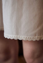 Detailed close-up of the scalloped lace trim on the hem of the Sueasyretro cotton bloomer pants.