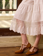 Close-up of the scalloped floral lace hem on Sueasyretro white bloomer pants. Perfect vintage style detail.