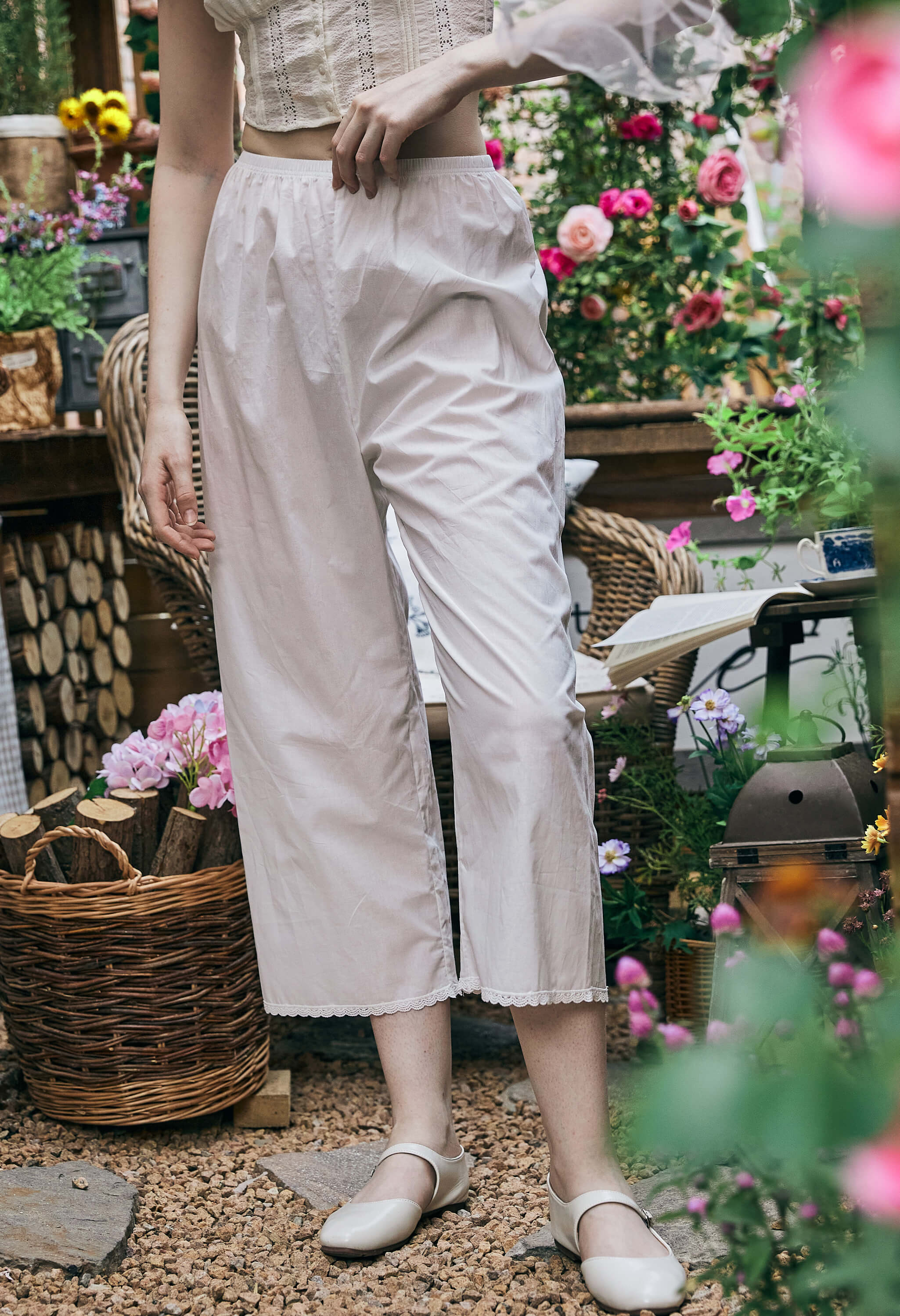 Front view of Sueasyretro bloomer pants. Wide-leg white cotton Pettipants with elastic waist and lace trim at the hem.