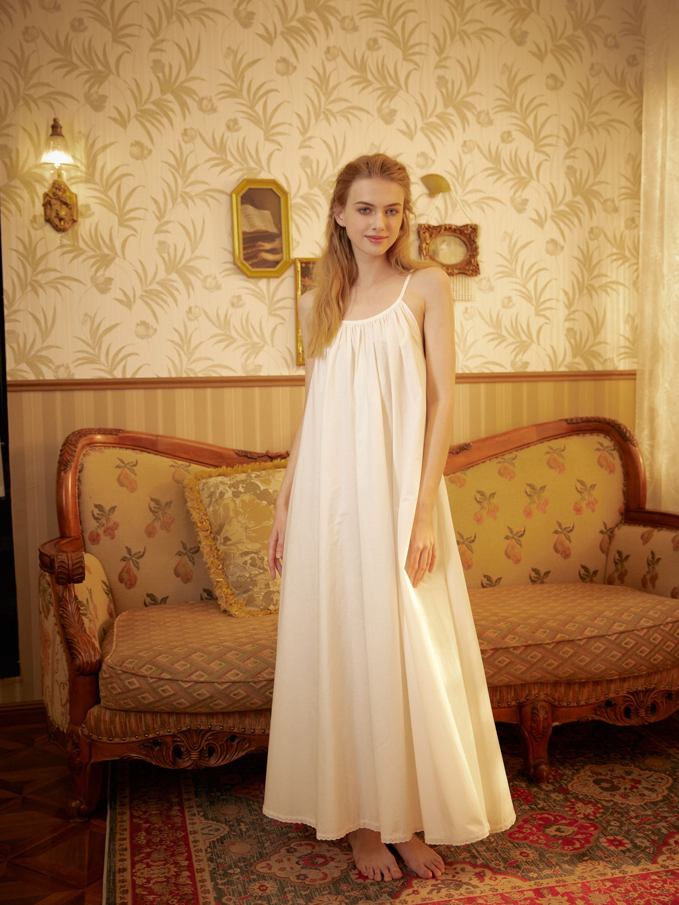 Full-length 100% cotton Victorian women's nightgown with spaghetti straps in a vintage interior setting.