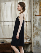 Women's black cotton full slip with spaghetti straps, showing comfortable fit and classic design - side view