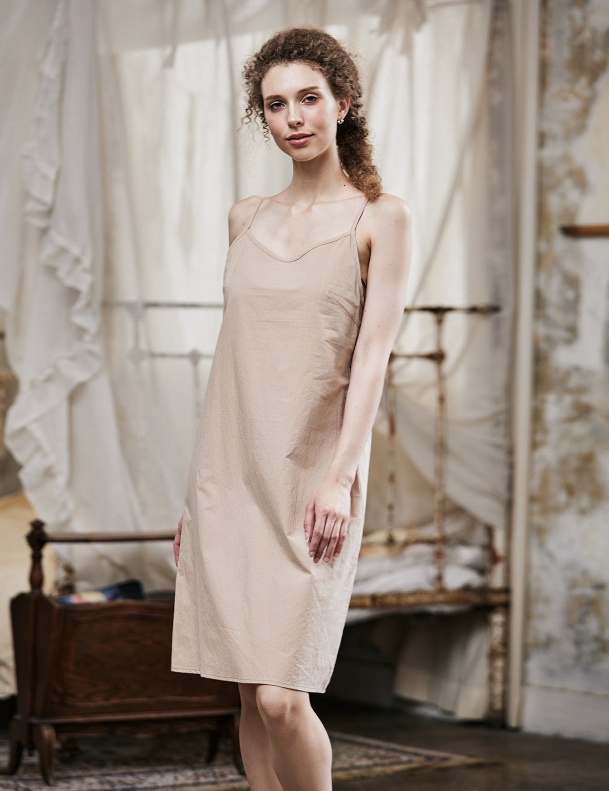Women's nude cotton full slip with spaghetti straps, showing comfortable fit and classic design