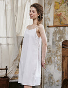 Women's white cotton full slip with spaghetti straps, showing comfortable fit and classic design