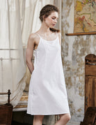 Women's white cotton full slip with spaghetti straps, showing comfortable fit and classic design