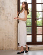 Side profile of Sueasyretro ivory 100% cotton half slip. Airy midi length petticoat with simple scalloped lace hem.