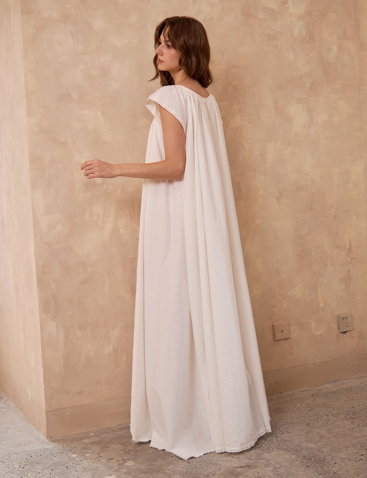 Back view of Sueasyretro ivory Victorian nightgown. Voluminous 100% cotton floor-length nightie with sleeveless lace.