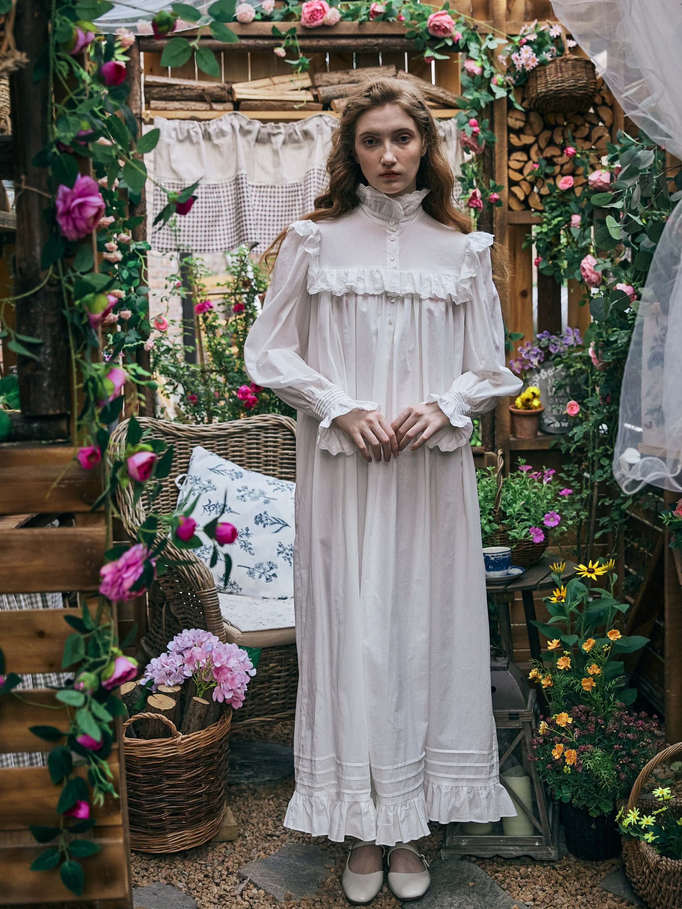 Full front view of a woman standing in the Ophelia white Edwardian cotton nightgown, showing the full length silhouette and hemline details.