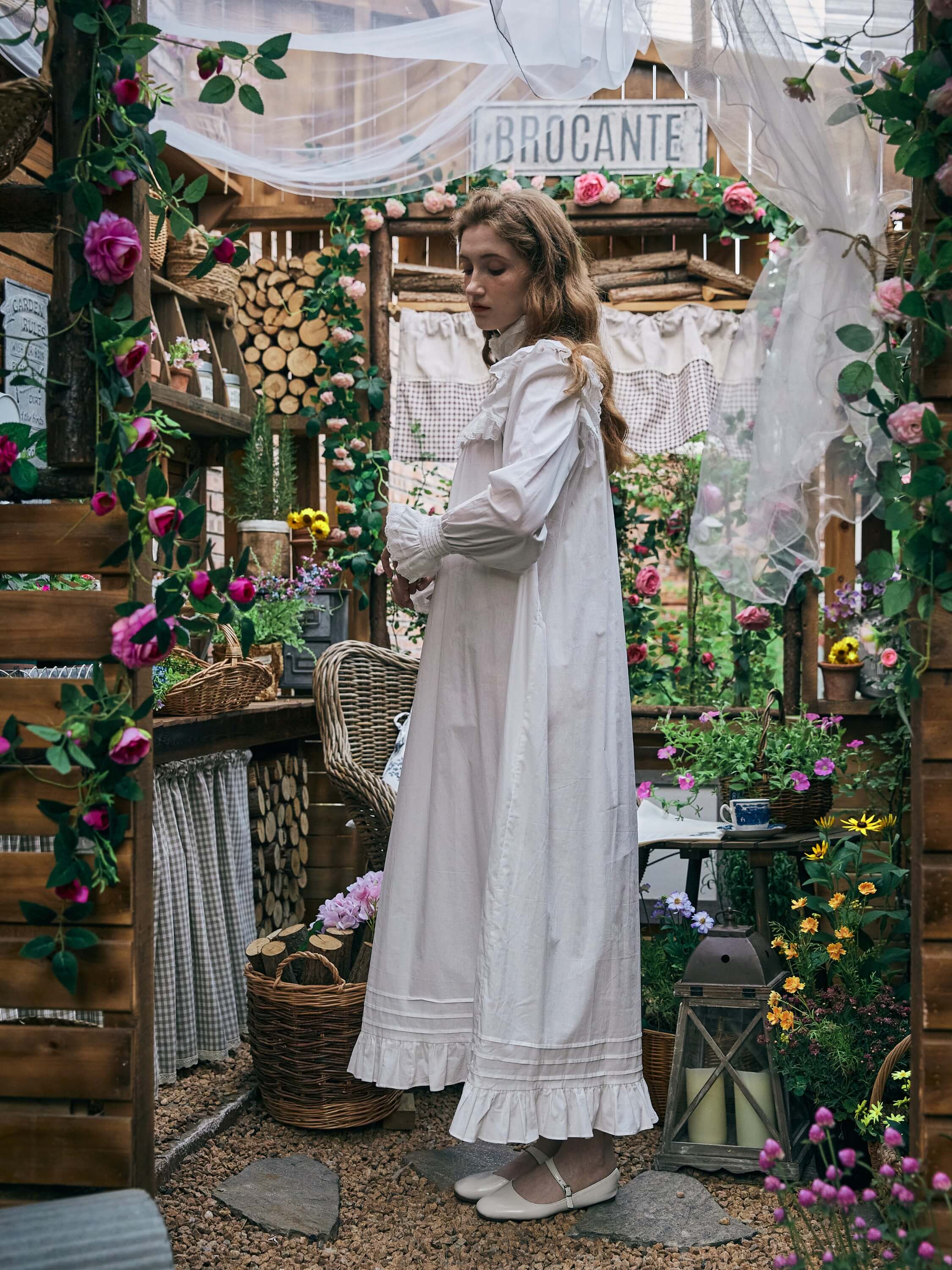 Full length side profile view of the Ophelia white Edwardian cotton nightgown, highlighting the voluminous bishop sleeves and flowing hemline.