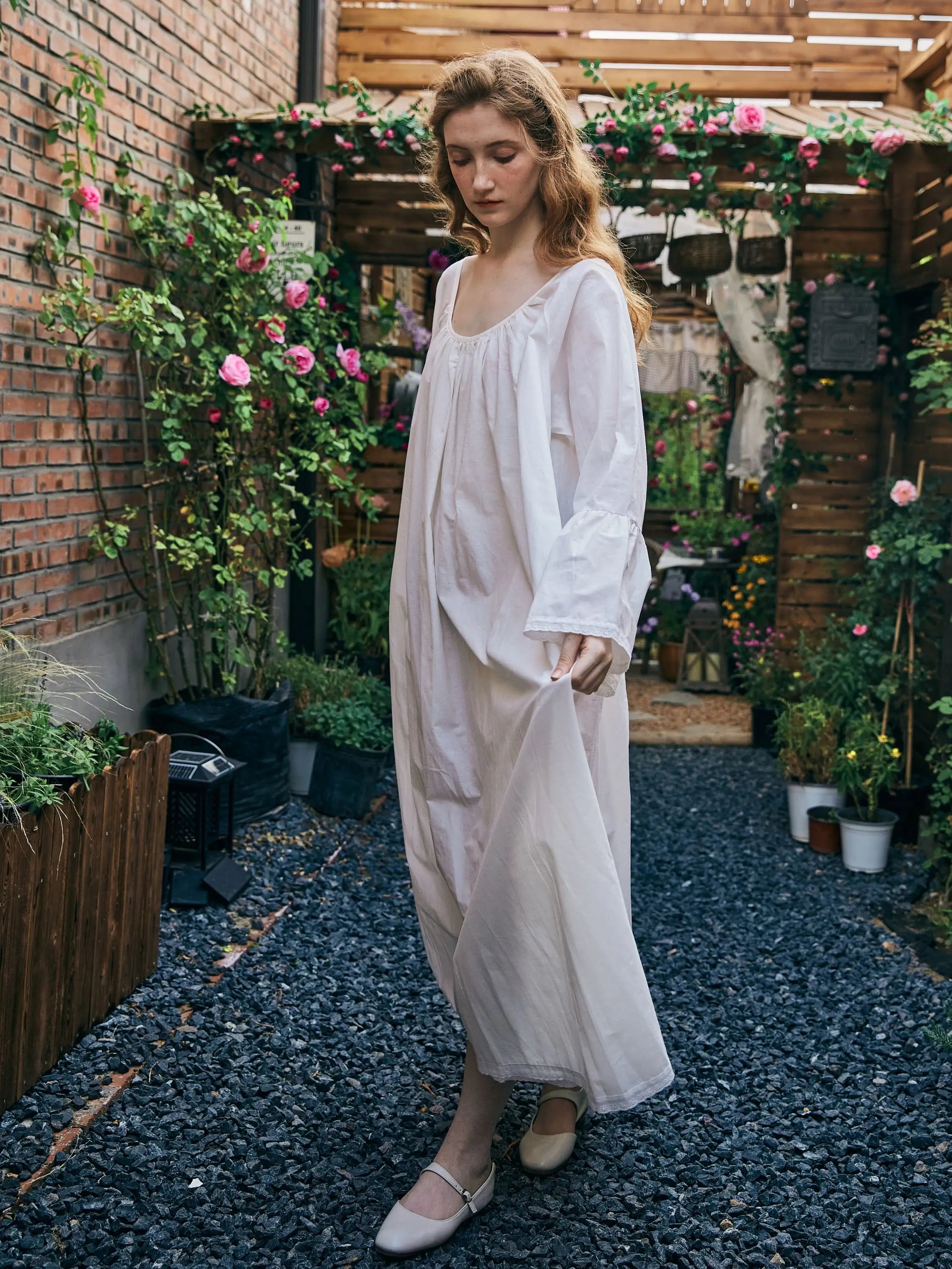Side view of plus size white cotton nightgown with delicate ruffled lace trim