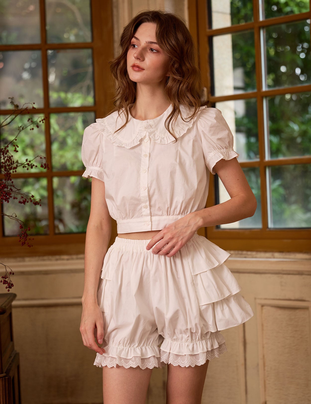 Close-up of model in Sueasyretro Ivory Cotton Ruffle Bloomer Shorts, with detailed top and ruffles at the waist.