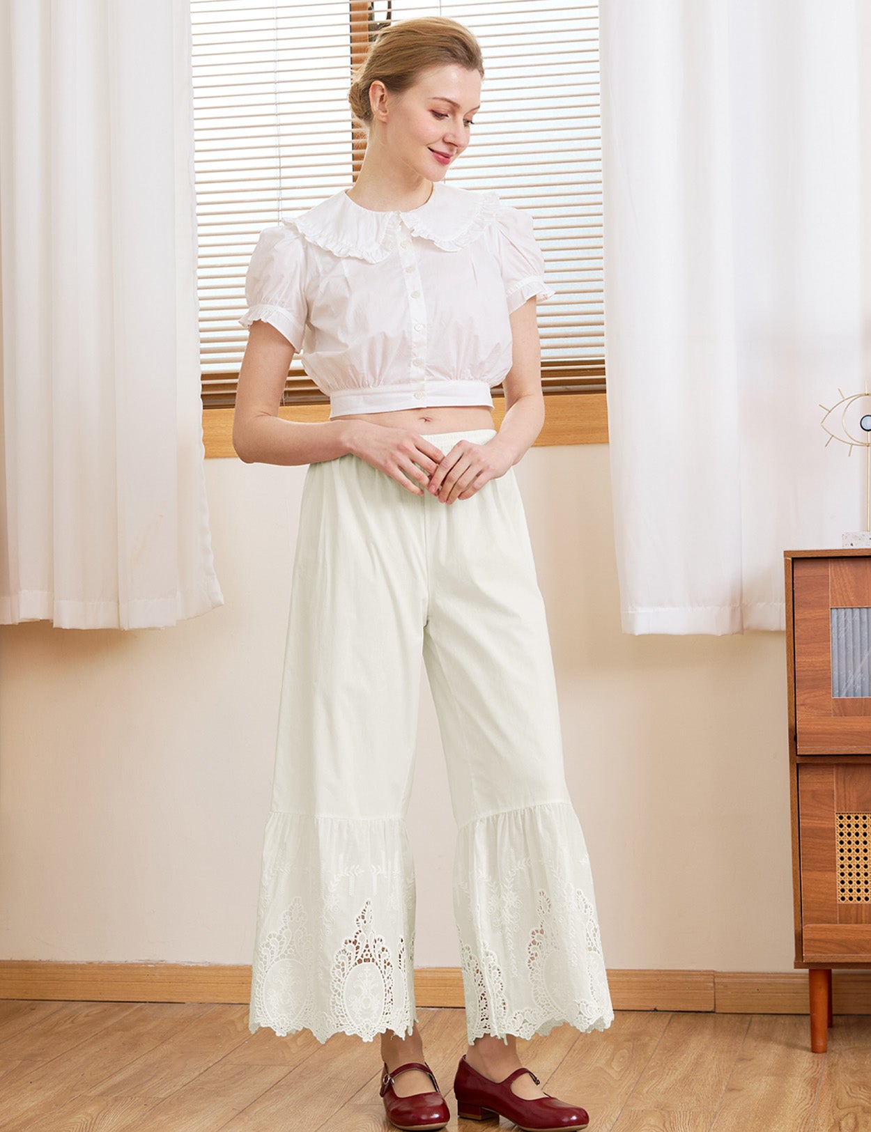 Woman wearing Sueasyretro cream vintage bloomer pants in 100% cotton for a relaxed, romantic look.